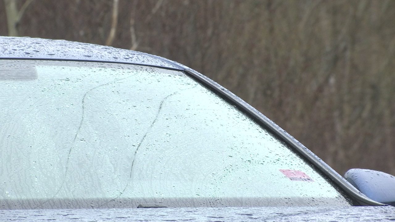 Rain falls on a windshield