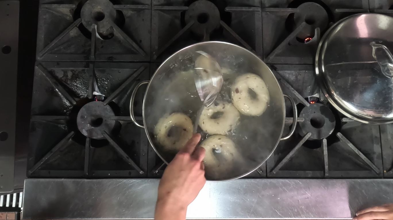 Bagels boiling in a pot