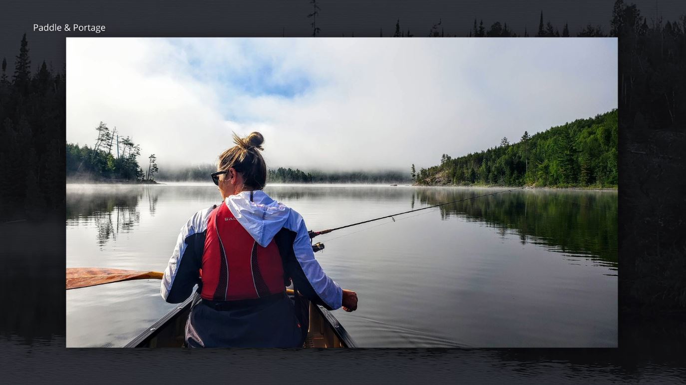 A woman canoeing with a fishing pole in the BWCA