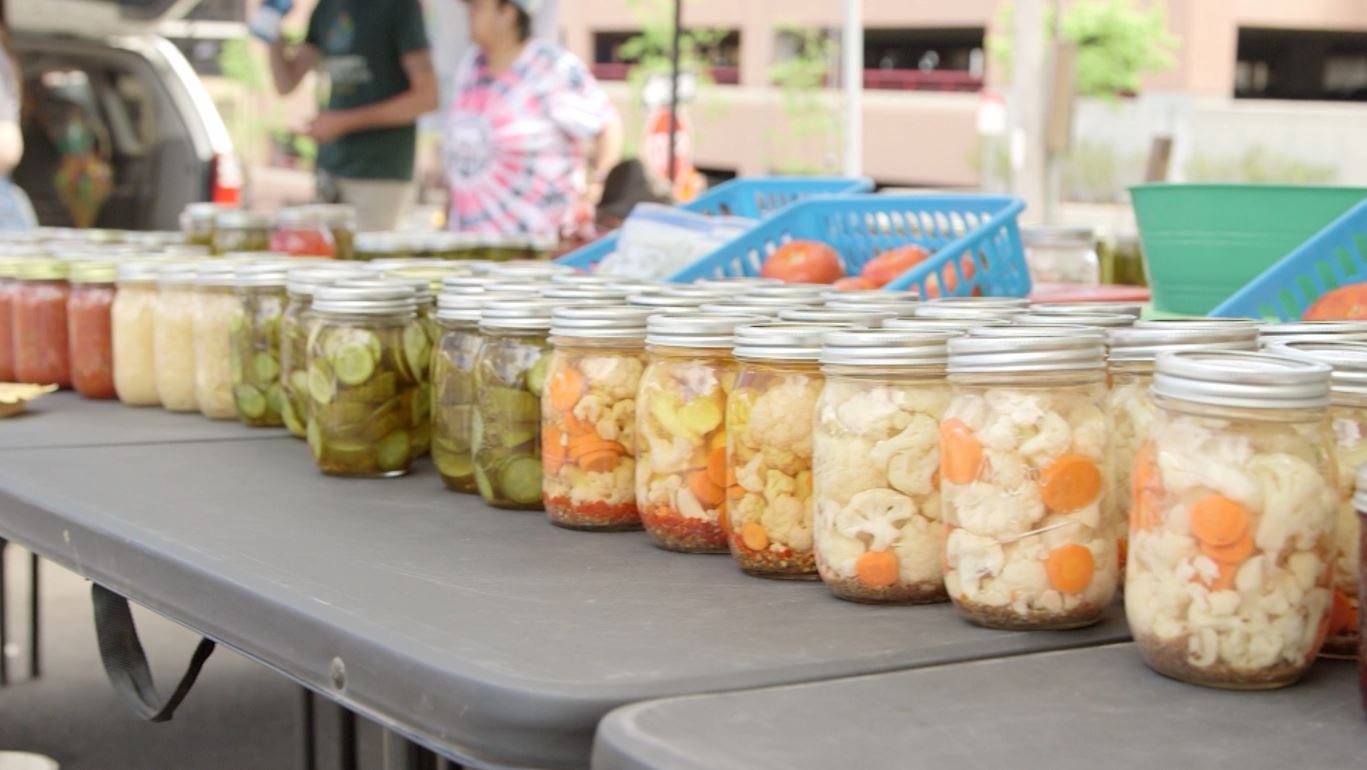 Jars of pickled vegetables at a farmers market