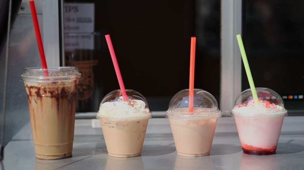 A flight with iced latte, iced chai and an Italian lemonade