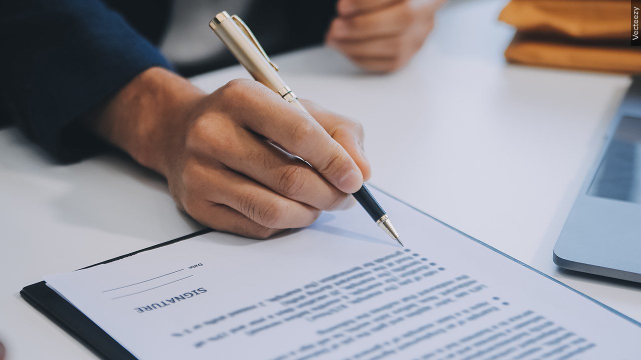 Someone signing a document