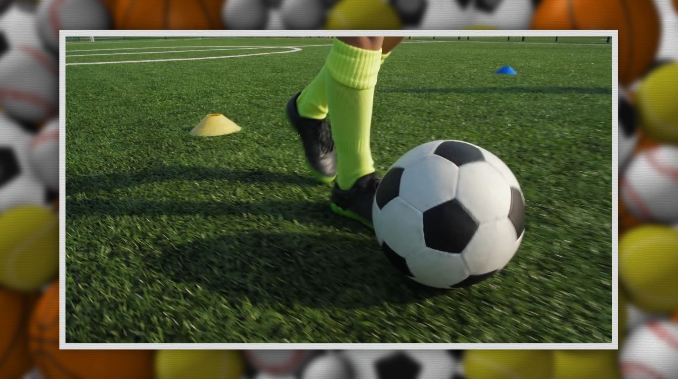 A kid kicks a soccer ball