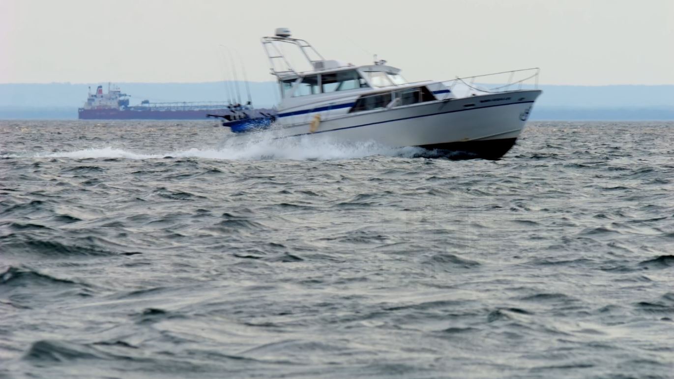 A boat cuts through choppy waves on Lake Superior