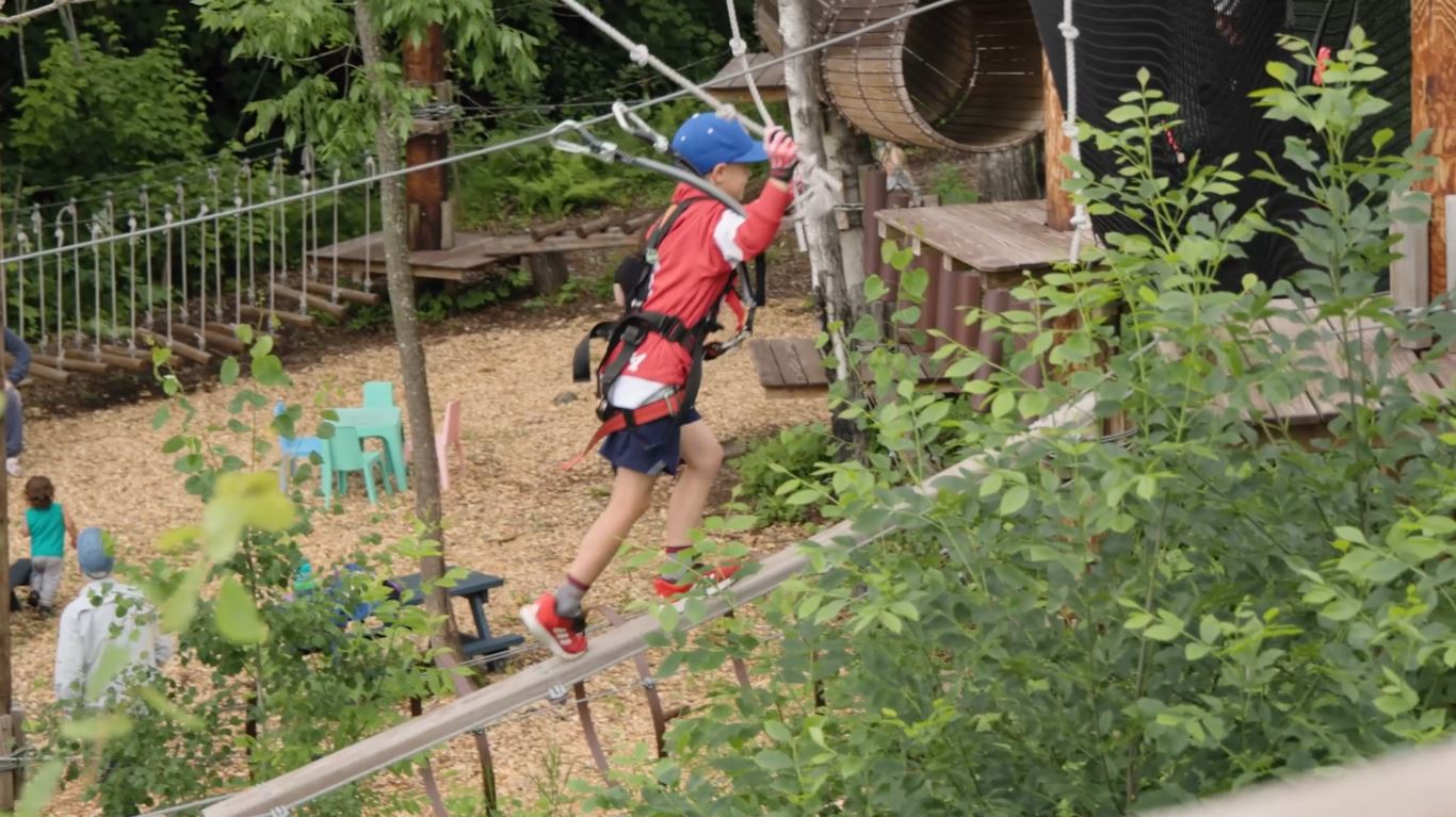 A boy on the ropes course at the North Shore Adventure Park