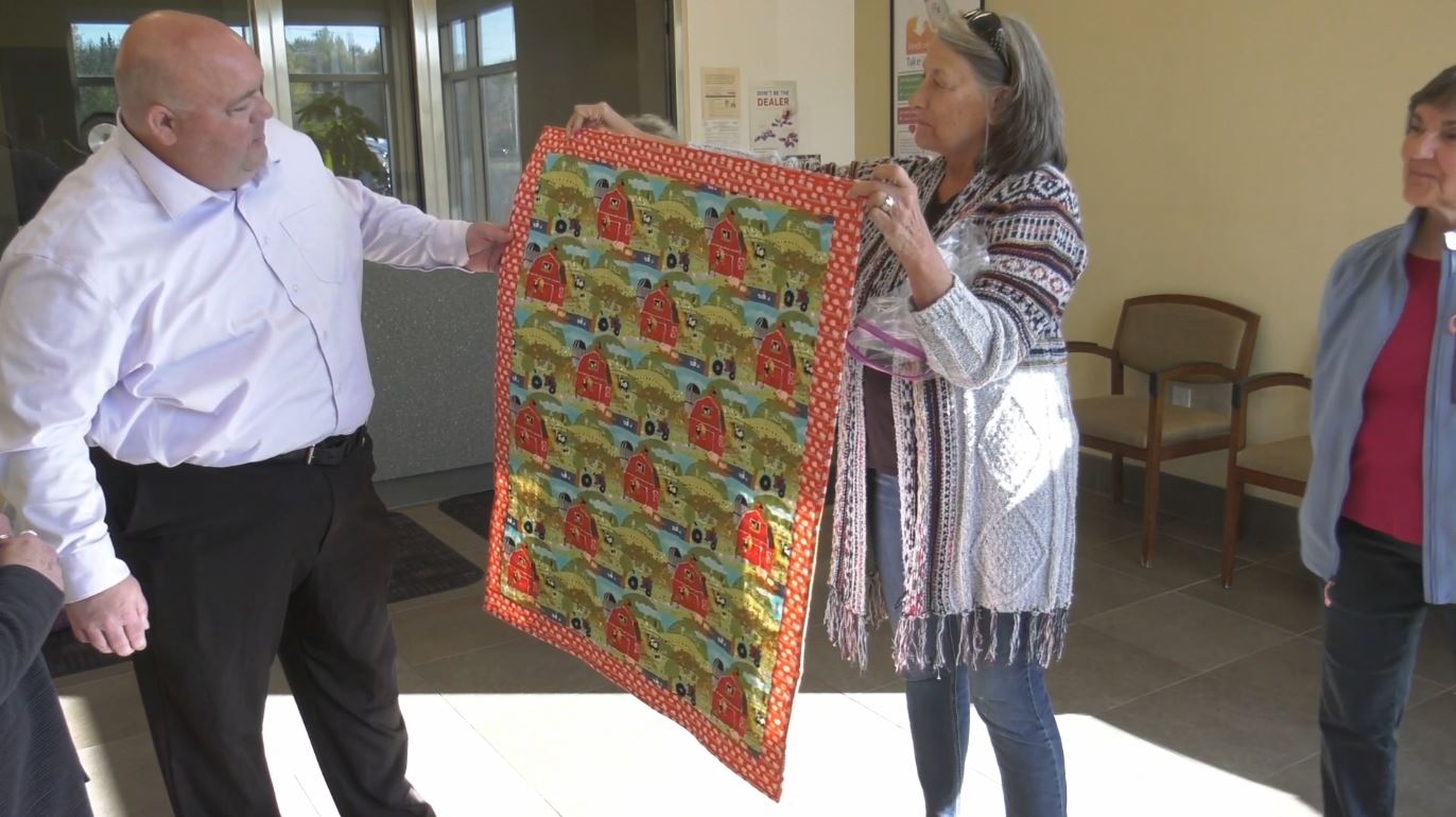 A Peace Quilt is presented to Duluth Police Chief Mike Ceynowa