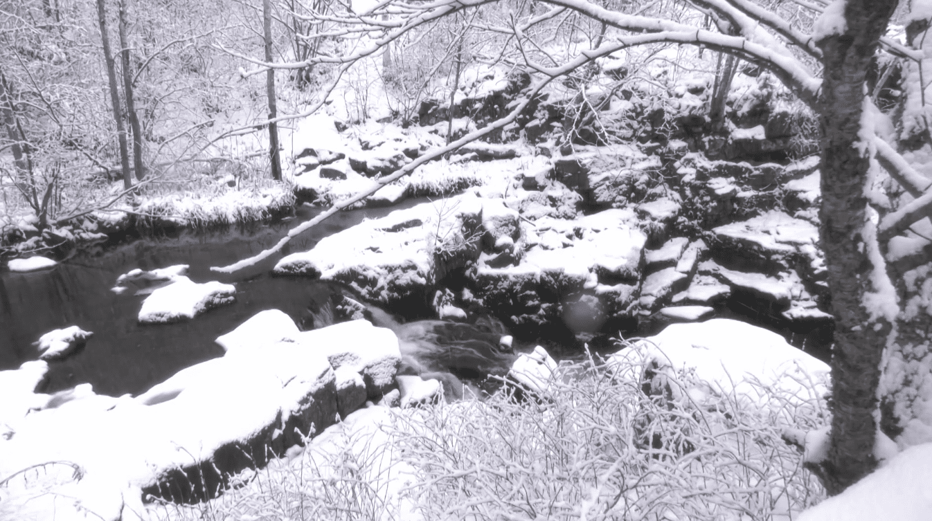 A small waterfall along a snowy Keene Creek