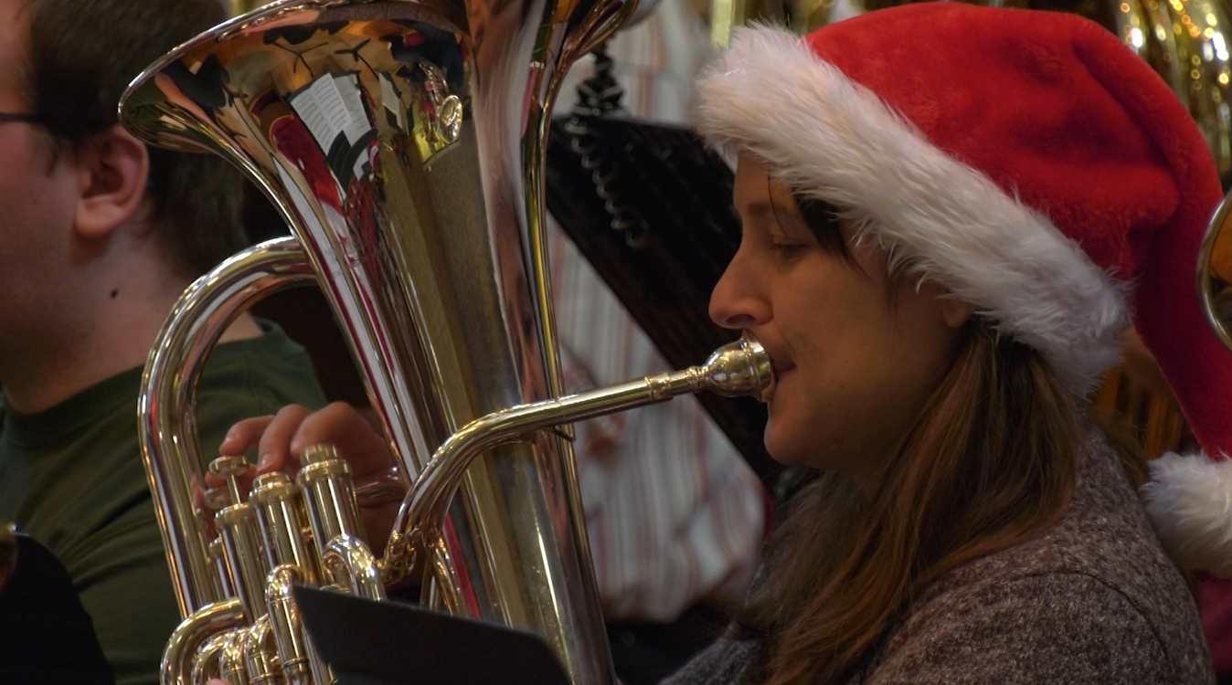 A woman plays the tuba