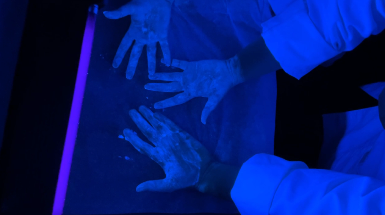 Dirty hands under a blacklight